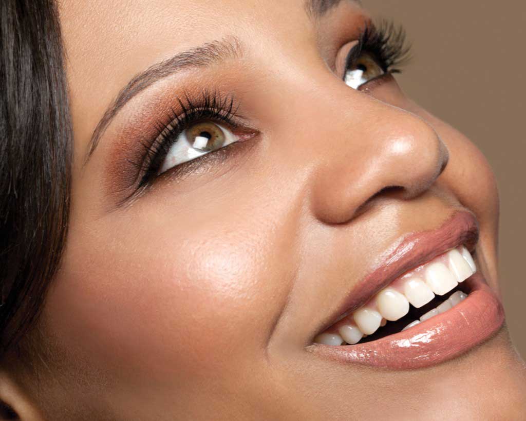 woman with eyelash extensions smiling